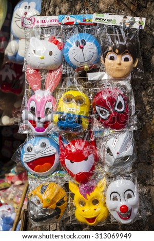 Hanoi, Vietnam - Sept 2, 2015: Colorful made in China minions, doraemon, spiderman masks for sale at an old street in Hanoi quarter streets area in time of lunar August full moon festival.