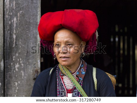 Sapa, Vietnam - Sep 7, 2015: Woman from Red Dao minority group wearing traditional attire and headdress in Sapa, Lao Cai Province, Vietnam.