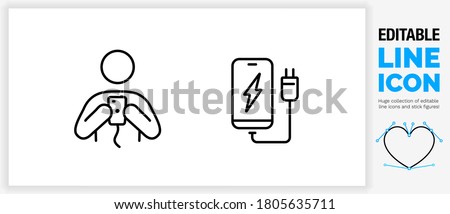 Editable stroke weight line icon of a stick figure person charging a mobile at an electricity point or location with the man holding his digital phone with the cable in the plug in a black eps vector