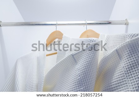 Bathrobes hung in the closet of hotel room