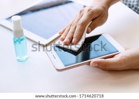 Similar – Image, Stock Photo Hand cleaning a phone screen with wet antibacterial wipes to avoid virus contamination.