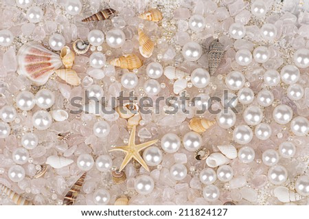 background of sea shells with pearls and rose quartz
