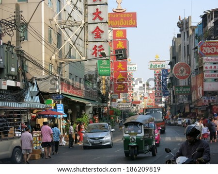 Bangkok, Thailand Ã¢Â?Â? December 22, 2013 Ã¢Â?Â? A view of China Town in Bangkok, Thailand.  Street vendors, pedestrians of both locals and tourists, and shoppers in China Town. There are cars on the road.