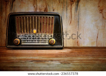 still life with retro radio on the floor over wooden background