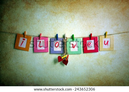 Vintage i love you write on paper photo frame and red heart over wall background, Valentine concept