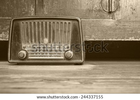 still life with retro radio on the floor over wooden background