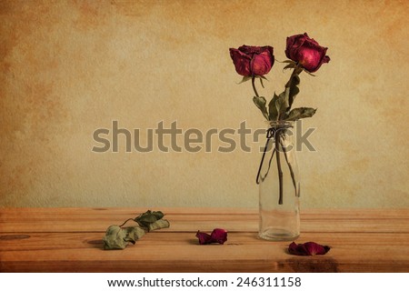 Still life with red rose on wooden table over grunge background, Valentine concept