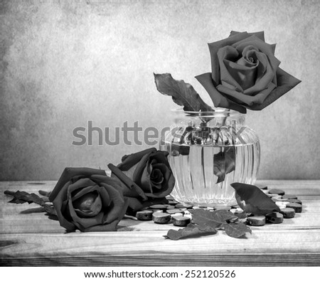 Still life with rose on wooden table over grunge background, Valentine concept, black and white