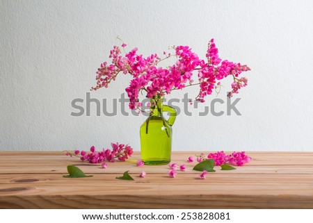 Still life with pink flowers on wooden table over grunge background, Valentine concept