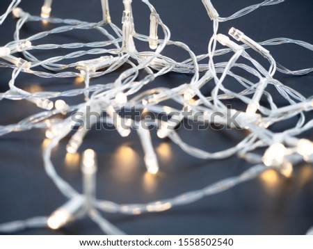 A close up of white string white fairy lights on a black background. Christmas festive decoration theme. Birthday party concept.  Zdjęcia stock © 