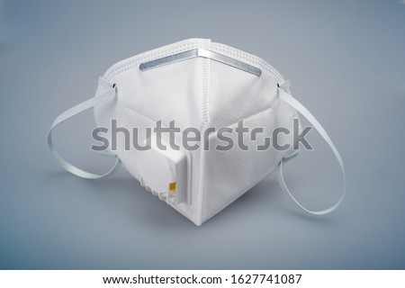White n95 mask on blue background, n95 respirator with ventilation valve, anti-haze mask, 商業照片 © 