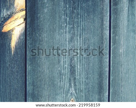 Wooden surface from boards with a light twig. Old boards. Wooden background.