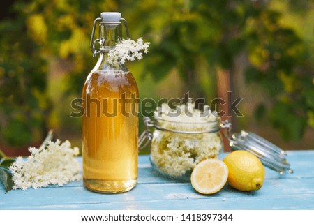 Similar – Image, Stock Photo Elder flower syrup ingredients: Elder branch, lemon and sugar in glass jar