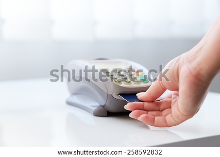 Woman pay by credit card in shop
