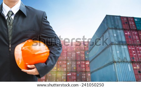 engineer orange helmet for workers security on the background of a logistic port.