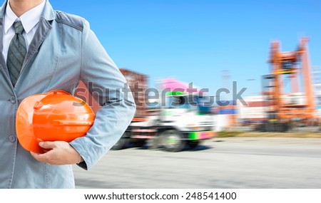 engineer orange helmet for workers security on the background of a logistic port.