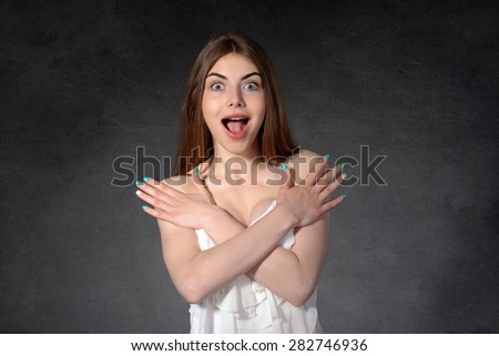 Concept human emotions. Girl shows fear and that she was not dressed against the dark background