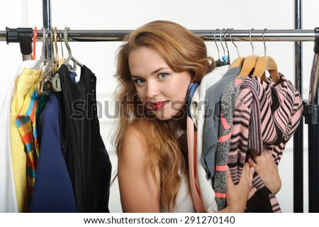 Girl chooses things at a clothing store, and shows how she likes it against the white background