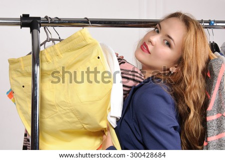Woman in formal wear excited buying things in a clothing store