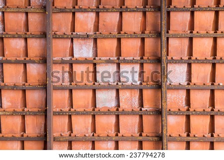 Baked Clay Roof tier on rusty iron bars