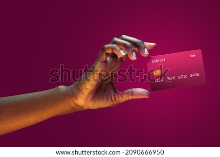 Close up african american female hand hold levitating mockup Bank credit card with online service on magenta background Foto stock © 
