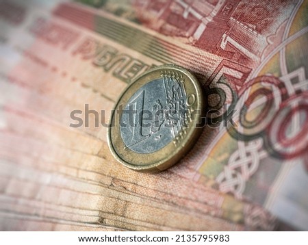 Euro and rouble. Foreign currency exchange. Russia and EU. Economic crisis. Russian money. Investment, business and finance. Emerging markets. Money background. Money in cash. Euro coin on roubles Foto stock © 