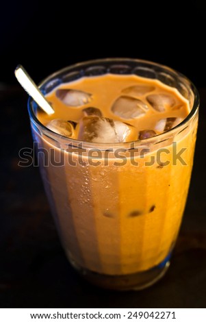 Glass Of Cold Iced Coffee On grunge tray, image dark tone