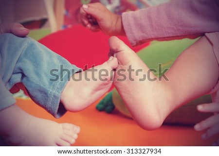 Brother and sister children\'s feet  in nursery
