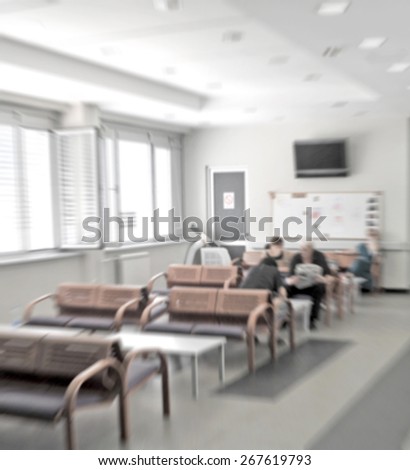 Different people sitting in a waiting room of a hospital
