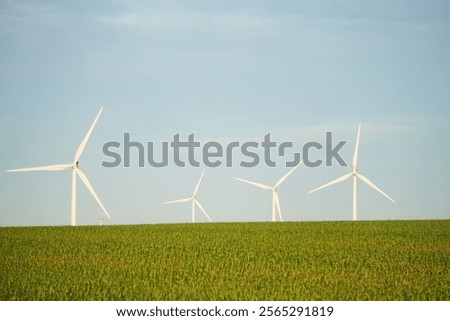 Similar – Image, Stock Photo Rotating windmill generating renewable energy wind power at land