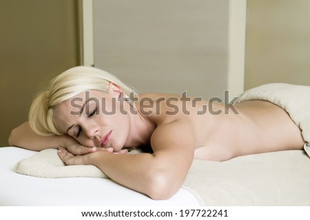 the girl at the spa, lying on the table wrapped in a towel and wait for your body massage treatment/ girl in spa center
