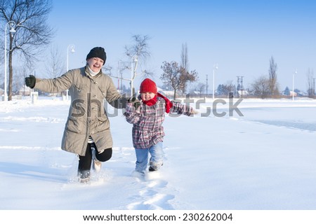 Mom and daughter running in the snow/running in the snow