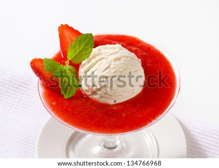 strawberry puree with scoop of lemon ice cream, in a tall glass