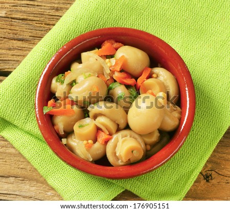 mushrooms with vegetable pickled in vinegar, served in a bowl