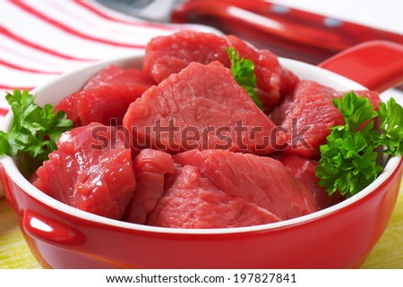 cut beef meat in the ceramic oven safe bowl