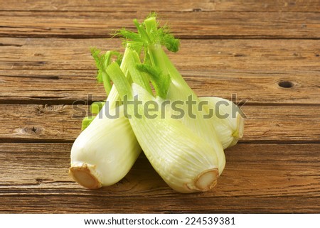 bulbs of fresh fennel on wooden table