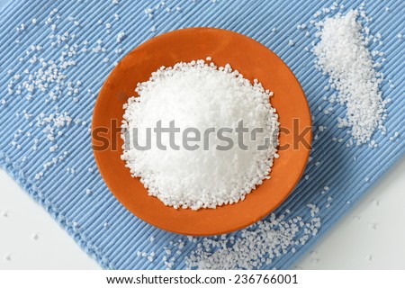 grain of salt spilled in the ceramic bowl