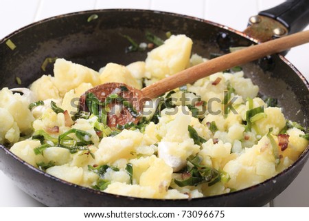 Crushed potatoes stir fried with spring onion and garlic