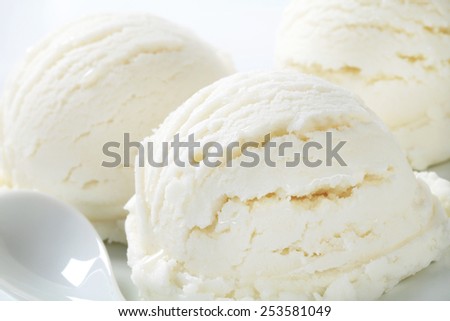 Scoops of white ice cream - lemon, vanilla or coconut flavor