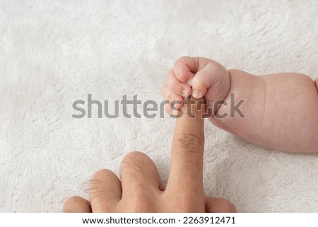Baby's right hand grasping his father's finger (0 years and 2 months, boy, Japanese) Сток-фото © 