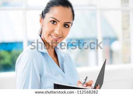 Portrait of attractive Indian businesswoman working from home