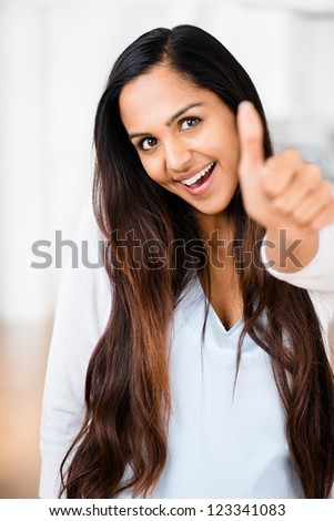 Beautiful Indian woman thumbs up happy smiling