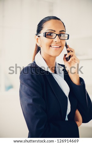 Indian business woman using mobile phone happy