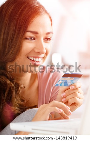 happy teenager woman using credit card shopping online laptop computer