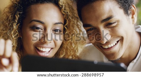 Couple using digital tablet touchscreen ipad watching movies