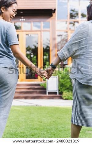Similar – Image, Stock Photo Lesbian couple holding hands under the table and hiding their love