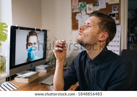 Man self test for COVID-19 home test kit. Coronavirus nasal swab test for infection. Telemedicine and Telehealth distribution of health-related services online. Internet doctor in video call Foto stock © 