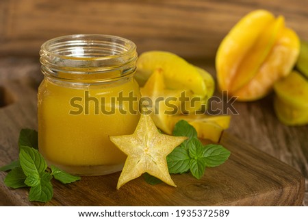star fruit, carambola or carambola juice, accompanied by fresh fruits on wooden table. Сток-фото © 