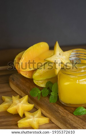 Carambola juice, carambola or star fruit, accompanied by fresh fruits on a wooden table, drink with a high energy level. Сток-фото © 