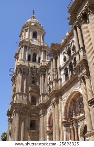 Decorative exterior, Malaga, Cathedral, Spain. Tourist attraction in Andalusia. Bell tower clock, sculptures, and columns